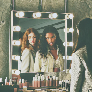Rihanna's Fenty Beauty ad, showcasing diverse models. Each model represents a different ethnicity. The ad highlights the brand's inclusivity. It is set in a high-end makeup studio, with the products prominently displayed.