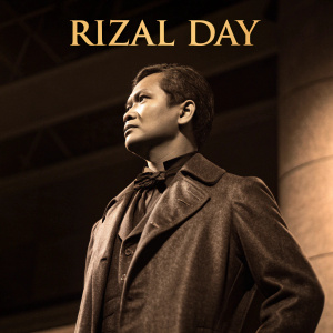 Jose Rizal, distinguished figure from the Philippines, standing tall in a dimly lit, sepia-toned photograph. 'Rizal Day' emblazoned prominently at the top. Close-up focus on Rizal's face and the significant text.