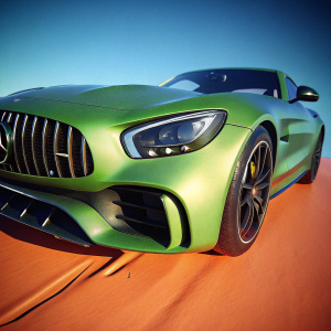 3D rendering of a green Mercedes-AMG GT R coupe. Modern, sleek design. Distinctive grille and accents. Against a plain white background.
