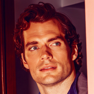 Close-up digital portrait of Henry Cavill. His face is illuminated against a dark background, highlighting every detail of his features. The illustration captures the intricacies of his facial structure in a realistic style.
