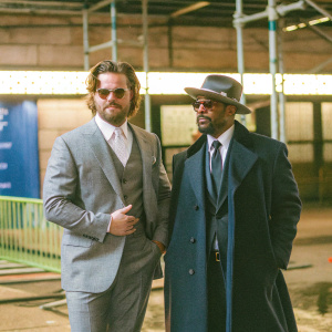Clayne Crawford and Damon Wayans, Sr. attending the New York Film Festival. Both are dressed in formal attire, Crawford in a gray suit, Wayans in a dark coat and fedora.