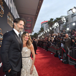 Joe Manganiello and Sofia Vergara at a Star Wars promotional event. Red carpet, crowd, flash photography.