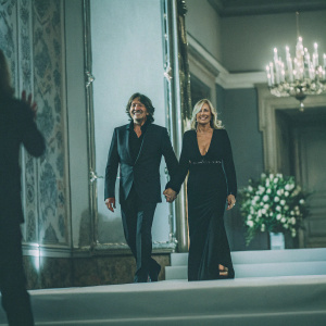 Patrizio di Marco and Frida Giannini at a luxury fashion gala. Dressed in elegant attire, surrounded by lavish decor.