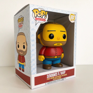 Limited edition Funko Pop! figure of Comic Book Guy from The Simpsons. The character stands in a brawny, simplistic, and cartoonish style. The collectible is showcased within its distinctive packaging box.