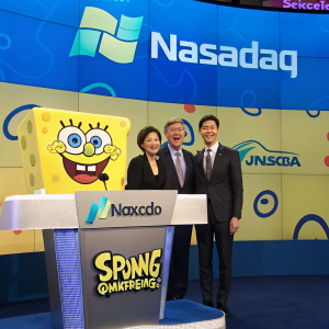 Formal attire-clad individuals posing in front of SpongeBob SquarePants-themed NASDAQ podium. Festive atmosphere, colorful backdrop with NASDAQ and SpongeBob logos