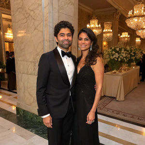 Adrian Grenier and Karesse Grenier, dressed in formal attire, at a charity gala. Elegant marble backdrop.