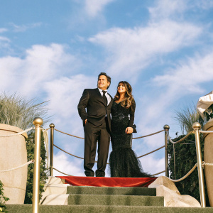 Emilio Estevez and Paula Abdul attending the New York City film premiere. Wearing elegant black suits and gowns.