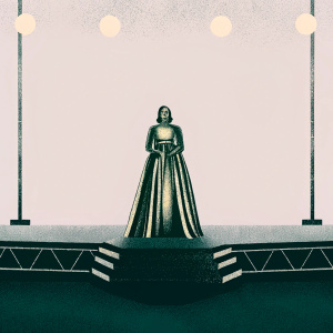 Padma Lakshmi in an elegant gold and black gown at the Met Gala. She stands confidently on a black stage with minimalistic decor.