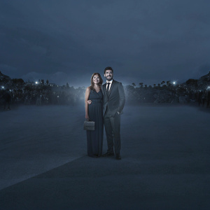 Formal portrait of Mariano Di Vaio and Eleonora Brunacci. The vibrant crowd and flashing cameras in the background.