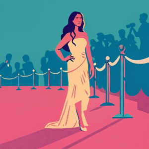 Janina Gavankar at the True Blood premiere, dressed in a flowing beige dress with orange accents. She stands confidently on the red carpet, amidst promotional banners and paparazzi.