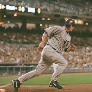 Mark Trumbo, wearing jersey number 45, sprinting across the field. Intense expression. Crowded stadium in the background, blurred for motion