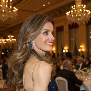 Princess Letizia of Spain, with a flowing brown and blonde layered hairstyle, smiles warmly at the annual royal gala dinner.