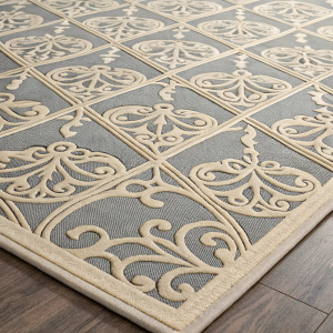 A close-up of the Safavieh Cottage Quincy rug, showcasing its intricate gray and beige diamond pattern with swirling details. The rug's flat woven texture is evident, offering a harmonious and elegant look suitable for indoor spaces.