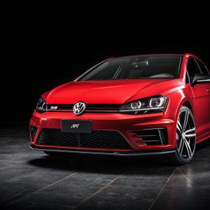 Red Volkswagen Golf R on a sleek, black background. The car's logo is prominently displayed.
