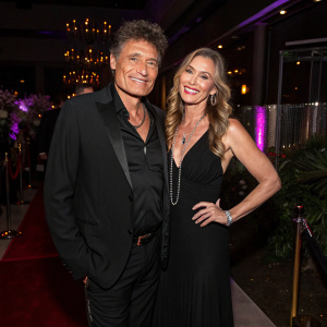 Steven Bauer and Jennifer Brenon attending the 'Better Call Saul' finale party. Chic black suit and elegant black gown