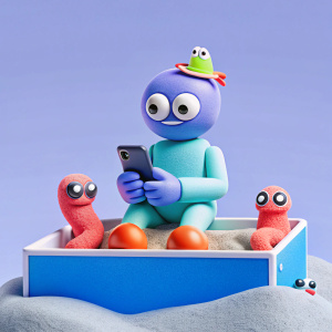 a guy is using his phone and sitting on a top of rectangular box which is filled with sand and some sand related creature crawling around it