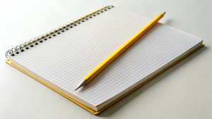  Yellow pencil on open spiral notebook with blank pages. Education, business, accounting, planning background