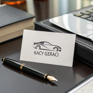 Business card featuring sleek car logo and contact details for Kacy Geraci. Situated on a glossy, black desk.