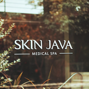 Modern logo design for Skin Java Medical Spa. The logo features a sleek black backdrop with the company name 'Skin Java Medical Spa' in bold letters. Below, the logo uses elegant script with subtle brown accents. The design is contemporary and visually appealing.