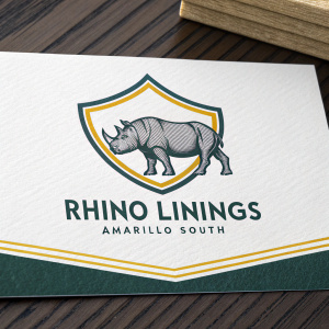 Business card design for Rhino Linings Amarillo South. Features rhino and shield logo, name, office address, and phone number.
