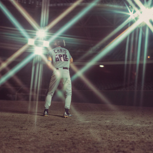 Chris Archer, baseball player, in action. Dark stadium, vibrant spotlights. Focused stance, jersey number visible