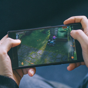 A Razer Phone displaying a high-resolution gaming scene from Arena Valor. Dark gradient background