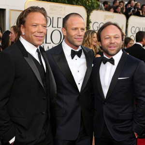 Mickey Rourke, Jason Statham, and Stephen Graham at the Golden Globe Awards. Formal attire, standing in front of a bustling crowd.