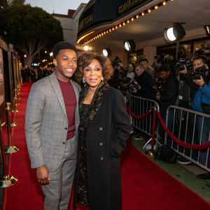 Calvin Lockhart and Diahann Carroll at a press junket for 'The Roadhouse'. Red carpet, photographers, fans in the background.