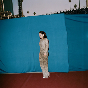 Gloria Estefan, in a shimmering leopard print dress, gracing the red carpet. The vibrant backdrop of the Grammy Awards.