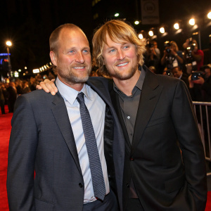 Premiere night at the cinema. Woody Harrelson, balding, with scruffy beard, and Owen Wilson, with tousled hair, posing together on the red carpet.