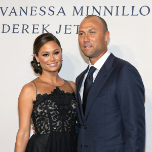 Vanessa Minnillo and Derek Jeter attending the annual charity gala. Vanessa dons an elegant black gown with intricate lace detailing. Derek is in a sophisticated navy suit. Both are posing formally in front of a plain backdrop. Foundation's logo prominently displayed.