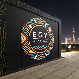 Alaanak EGY's logo, a vibrant blend of geometric patterns and sleek lines, set against a sleek black backdrop.