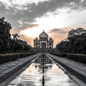 Sunset view of Safdarjung's Tomb in Delhi, India. Majestic red sandstone monument surrounded by lush greenery.