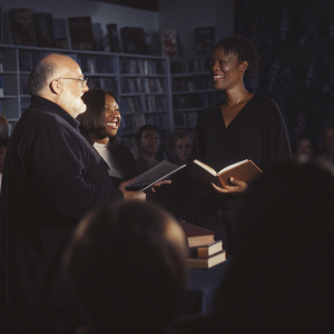 Rob Reiner, Aisha Tyler, and Stephanie Miller chatting at a book signing event.