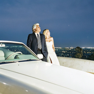 Jay Leno and Gwyneth Paltrow at The Tonight Show. Formal attire, night cityscape backdrop