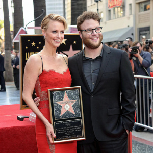 Charlize Theron and Seth Rogen, standing side by side, at the Hollywood Walk of Fame unveiling ceremony.