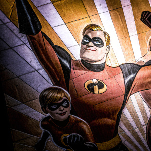 A vivid illustration featuring The Incredibles. Characters in dynamic poses. Warm color palette: red, orange, black, yellow. Abstract shapes form backdrop. Stylized, flat graphic design.