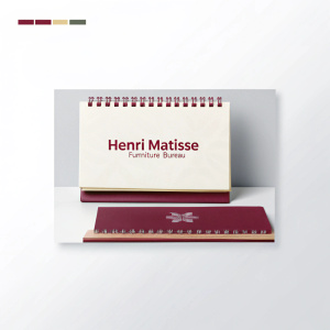 Generate an image of a notepad with the logo of the Henri Matisse furniture bureau from a photograph using the link https://www.recraft.ai/community?imageId=27a9adf4-ae1b-4d0a-8a18-52fe82c41ee2