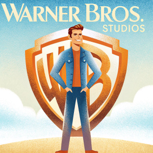 Paul Wesley at the Warner Bros. Studios event. The background is filled with the iconic WB logo. Wearing a denim jacket, he has a friendly demeanor and neat hairstyle.