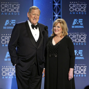 Ken Howard and Linda Fetters, dressed in formal attire, stand on the stage at the Critics' Choice Television Awards. The backdrop features AFI and TV Land logos.