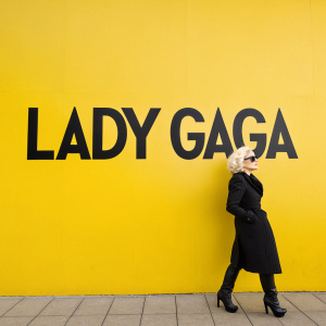 Lady Gaga's name in bold, sans-serif font. Black letters on a bright yellow background.