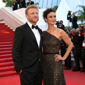 Kevin McKidd and Indira Varma at Cannes Film Festival. Wearing designer gowns and tuxedos. Star-studded red carpet event.