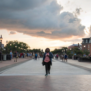 Mindy Kaling, playing Molly Patel, in a bustling city street scene. Warm tones, casual attire, surrounded by diverse passersby. Candid, documentary-style photograph.