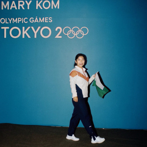Digital illustration of Mary Kom, Indian boxing champion. Wearing national colors: saffron, white, green. Olympic Games Tokyo 2020 logo backdrop