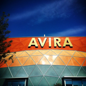 The vibrant logo of Avira, with its intricate geometric design, pops against a minimalist white backdrop. Bold text declares the brand's name.