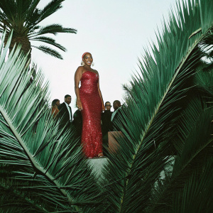 NeNe Leakes in a glittering red gown at the BET Awards, beaming at the camera.