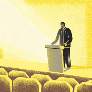 Xabi Alonso, in a black suit with Adidas logo, giving a speech. Dimly lit auditorium with minimal audience, spotlight on him