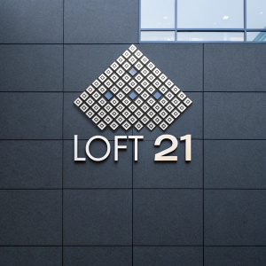Loft 21, modern logo design, composed of numerous tiny squares forming a geometric pattern.
