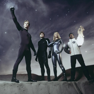 The Fantastic Four in action pose. Reed Richards, muscular Ben Grimm, sleek Sue Storm, and confident Johnny Storm. Cloudy, cosmic backdrop