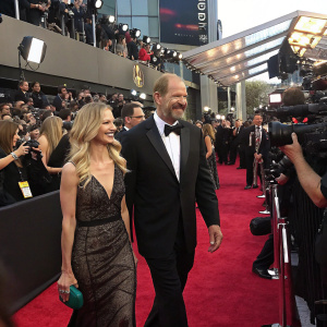 Bill Cowher and Veronica Stigeler attending a glamorous awards ceremony. Crowded red carpet with flashing cameras